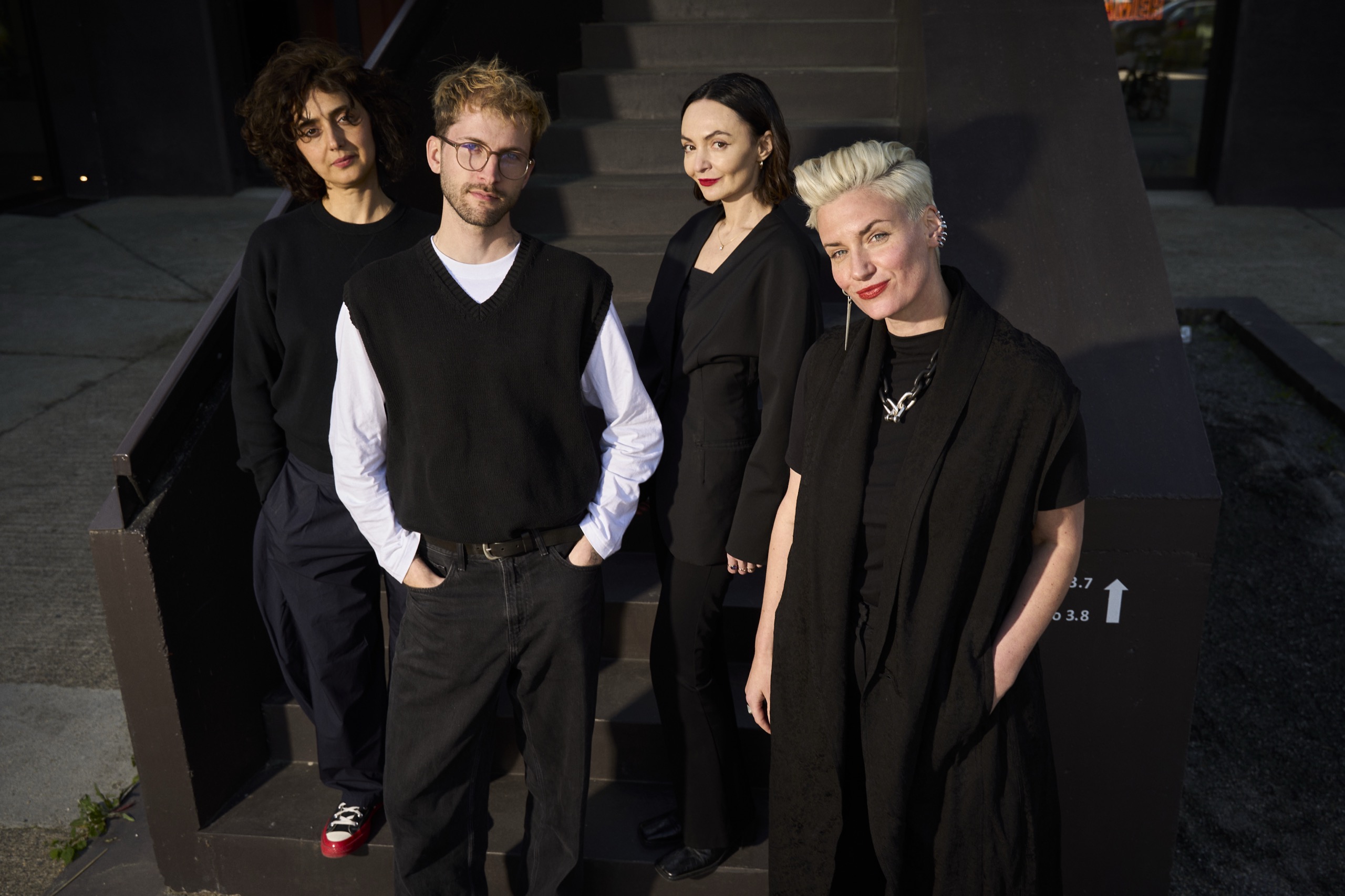 Members of the LA FLOR STUDIOS team on the studio staircase