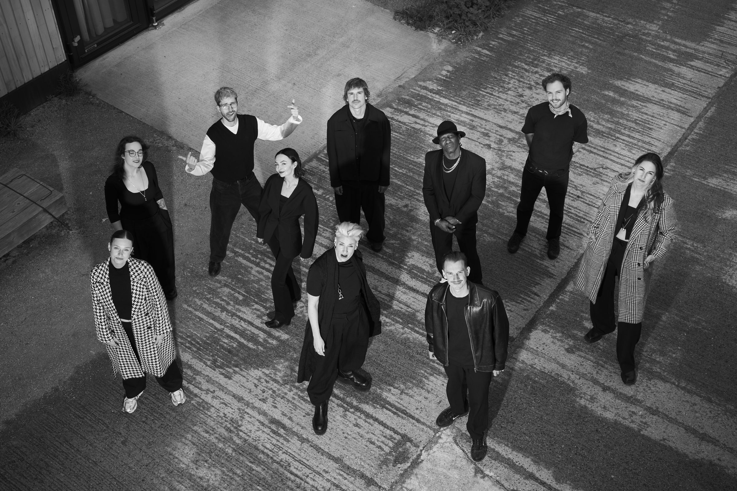 The LA FLOR STUDIOS team photographed from above, in black and white