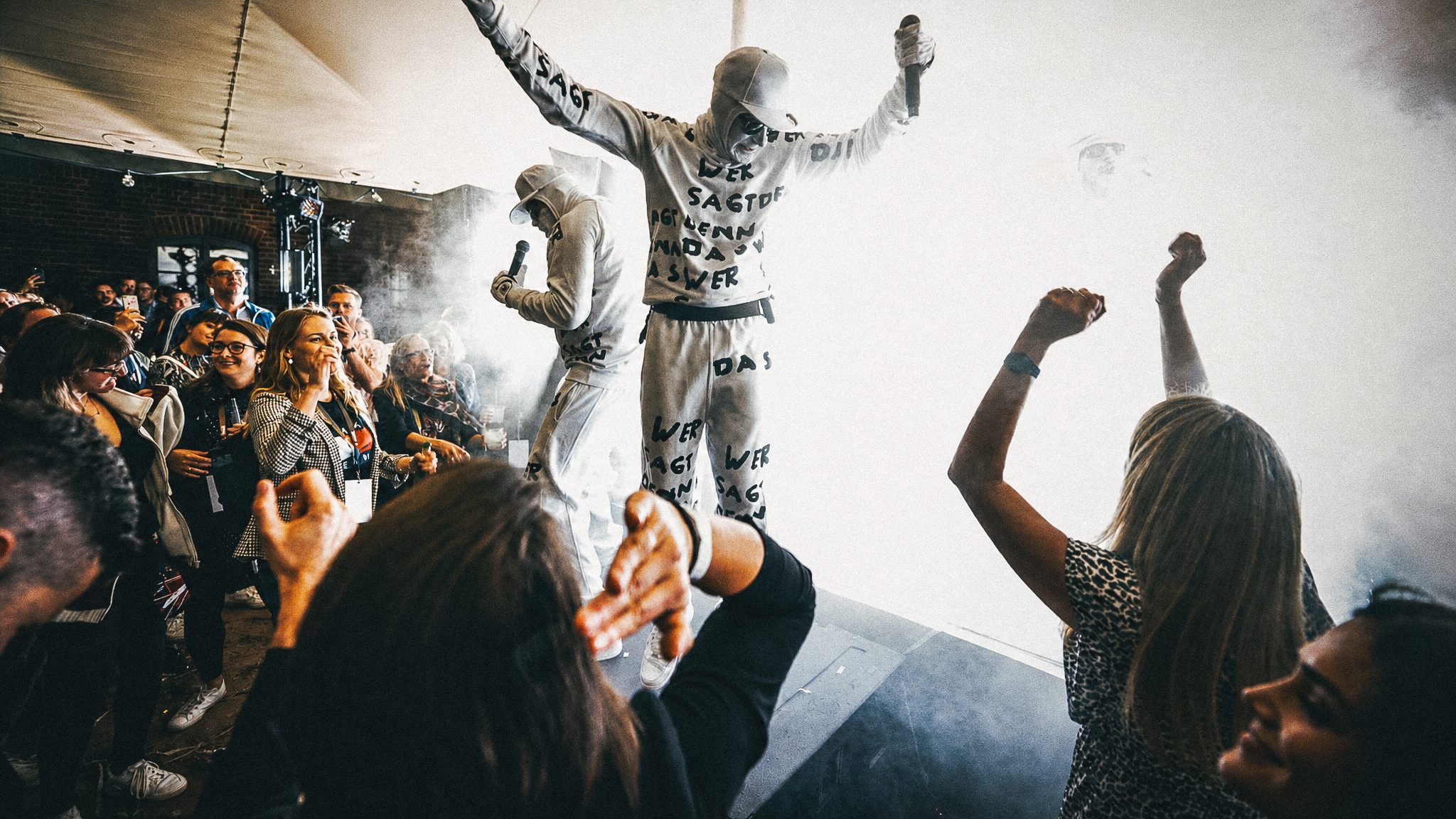 Crowd gathered under a mirror ball at a live event
